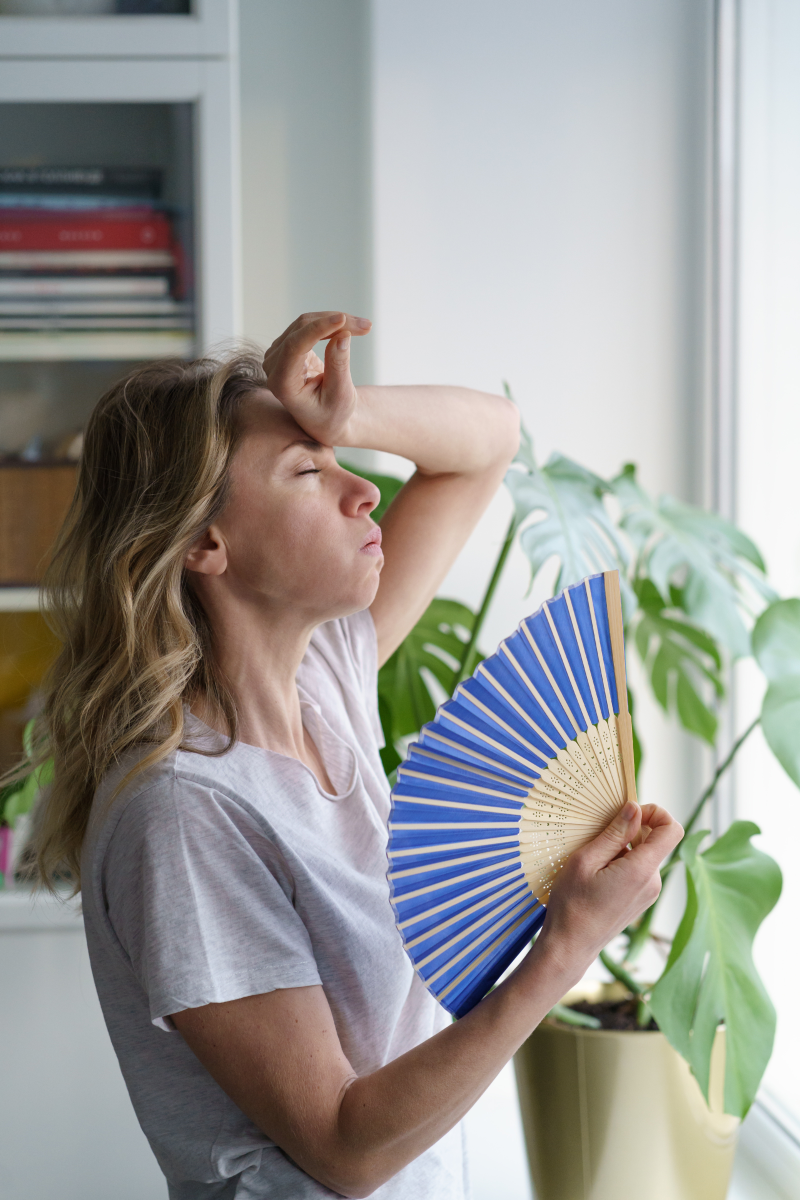 Woman in heatwave with fan